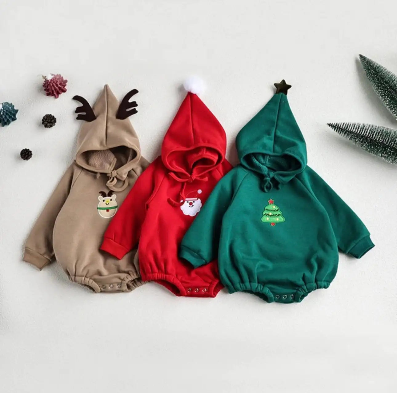 Flat lay of green baby Christmas romper – cozy one-piece outfit for holiday season in Canada and USA