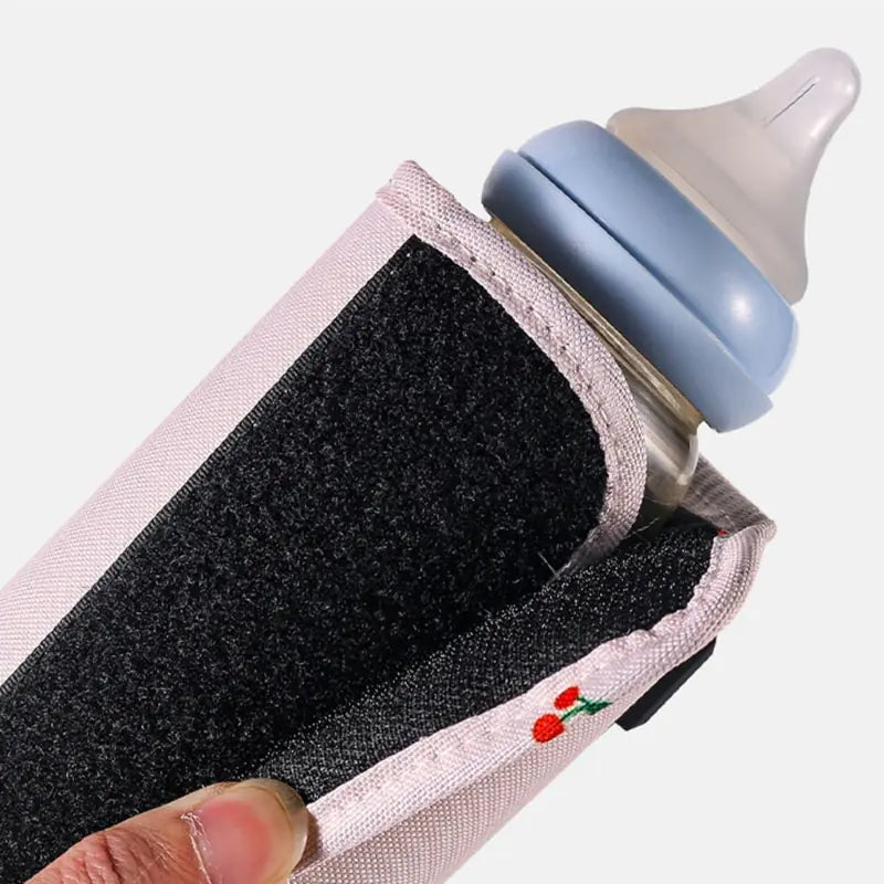 Baby using USB bottle warmer for milk on the go.